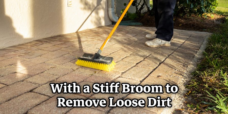 With a Stiff Broom to Remove Loose Dirt